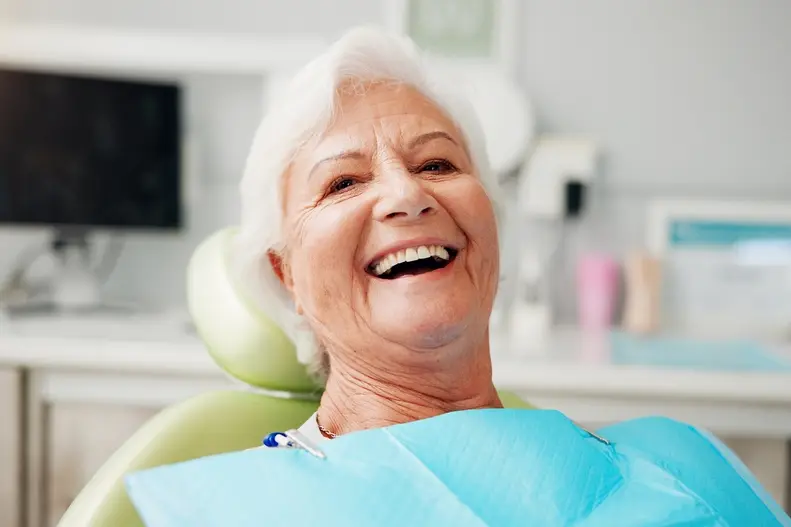 Laughing older woman in the dental chair
