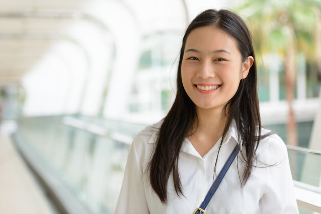 Smiling young woman with long dark hair